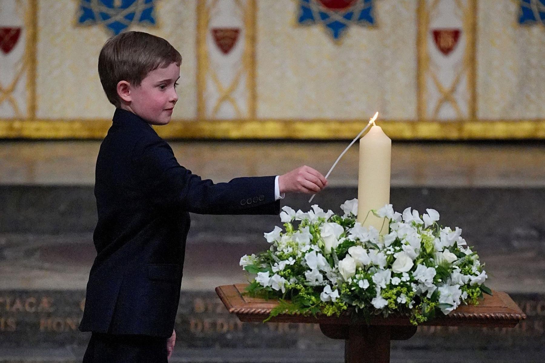 Boy lighting candle during service.