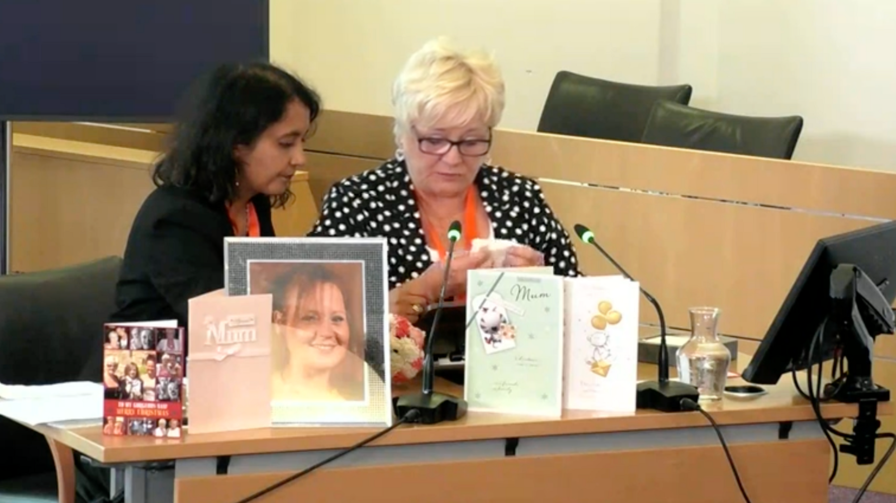 Martha Gaskell reading a statement regarding the death of her daughter Marion Turner at the Lampard Inquiry at the Civic Centre in Chelmsford.  She has her solicitor Priya Singh beside her and there are photos of her daughter and birthday cards from her daughter placed on the table in front of her.