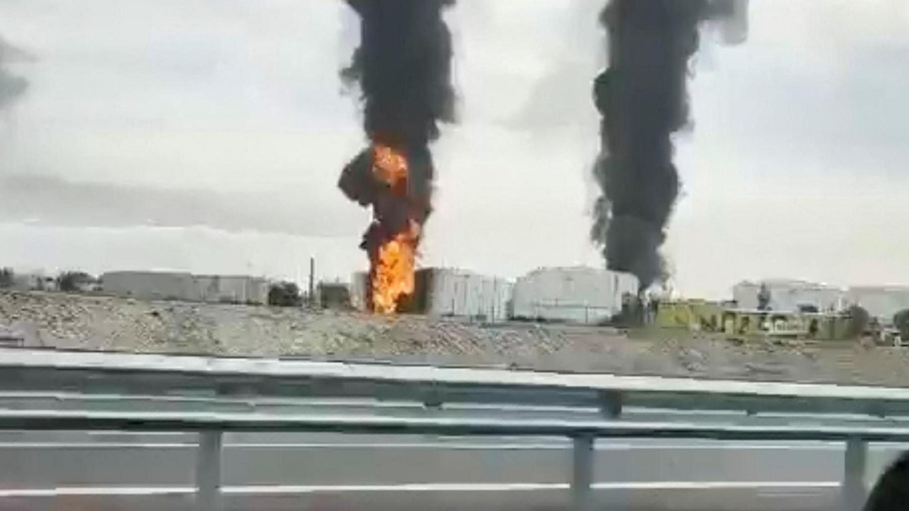 A photo from a moving car showing the depot on fire 