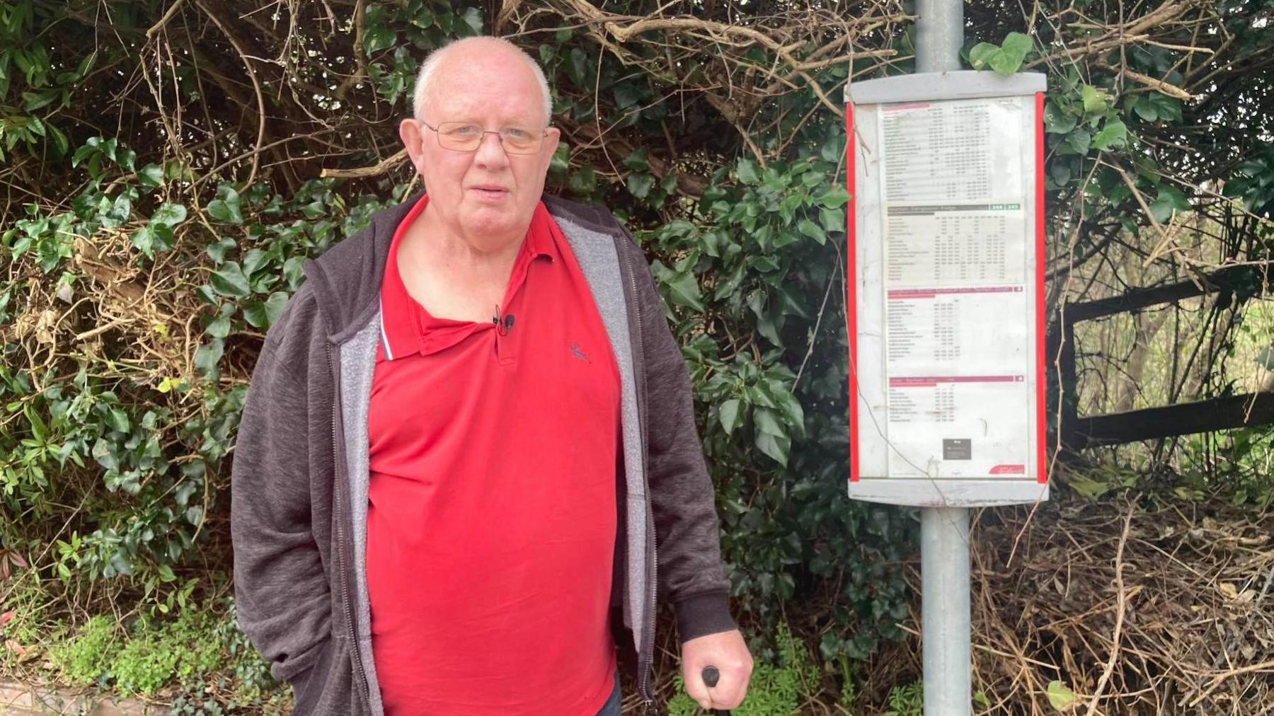 Richard Shannon stands at a bus stop