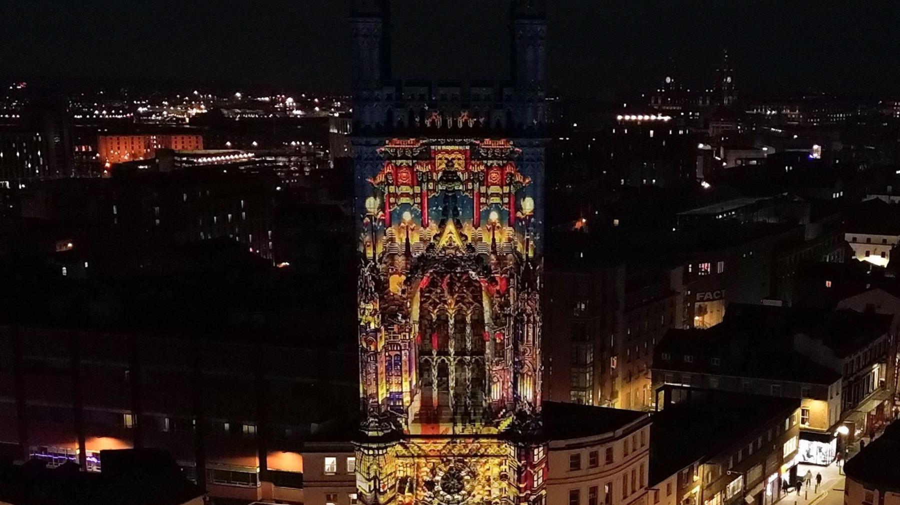 Image of Chinatown arch is projected on the tower of St. Luke's Church at night