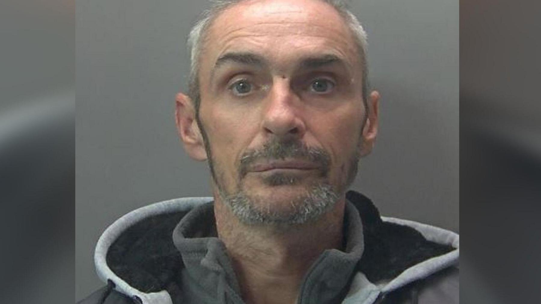 Daniel Willerton in his custody picture, wearing a grey hoodie