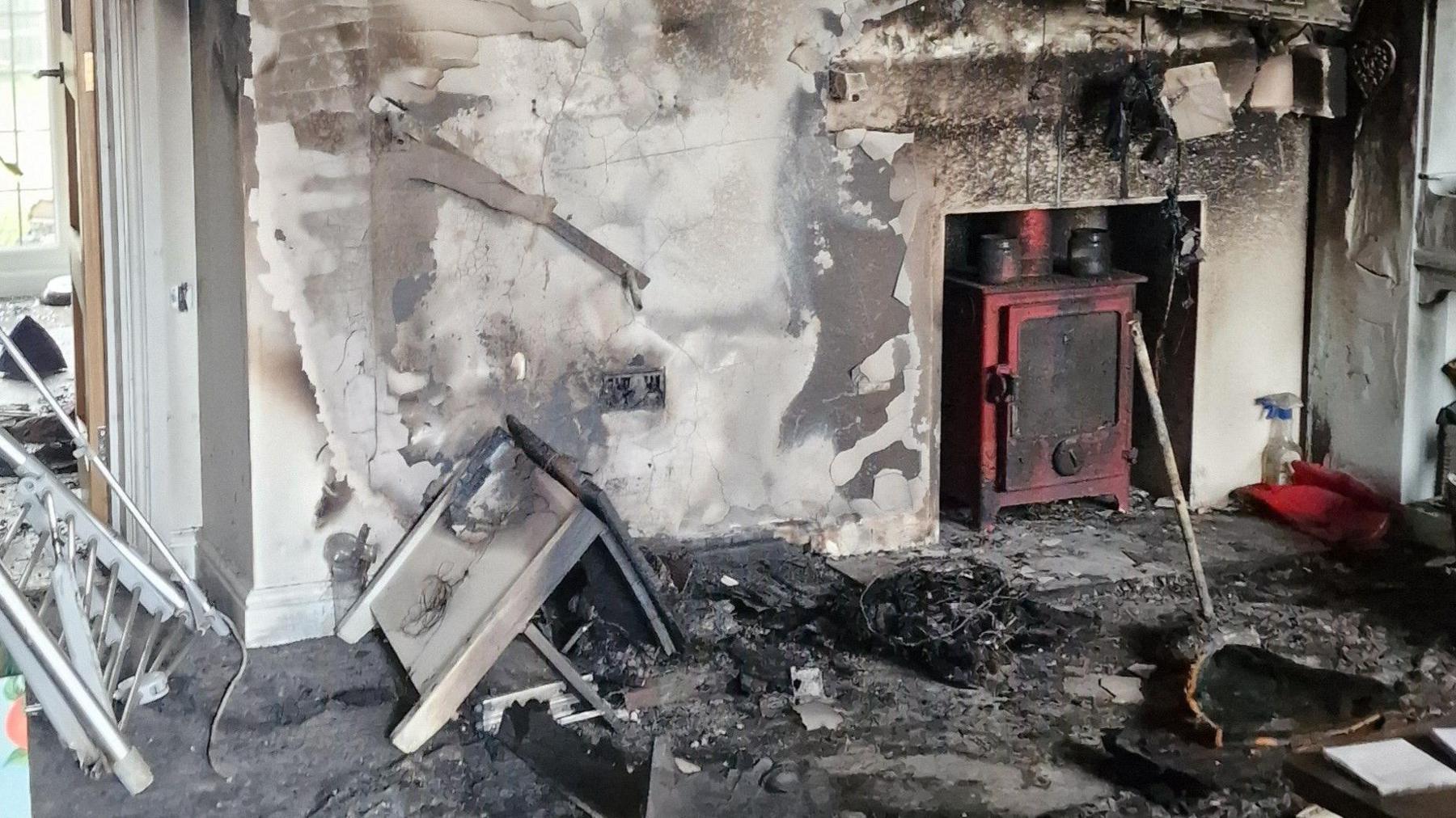 Extensive smoke damage can be seen in a living room inside a house