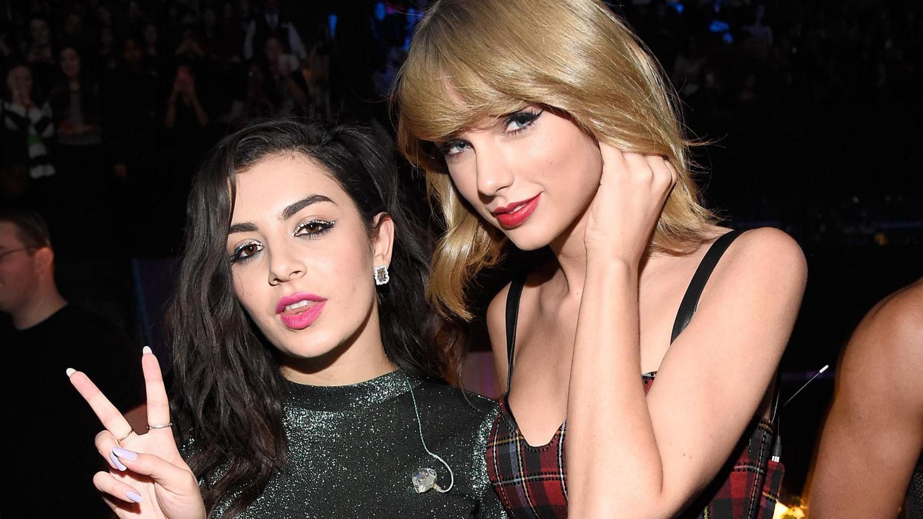 Charli XCX (L) and Taylor Swift pose backstage at iHeartRadio Jingle Ball 2014
