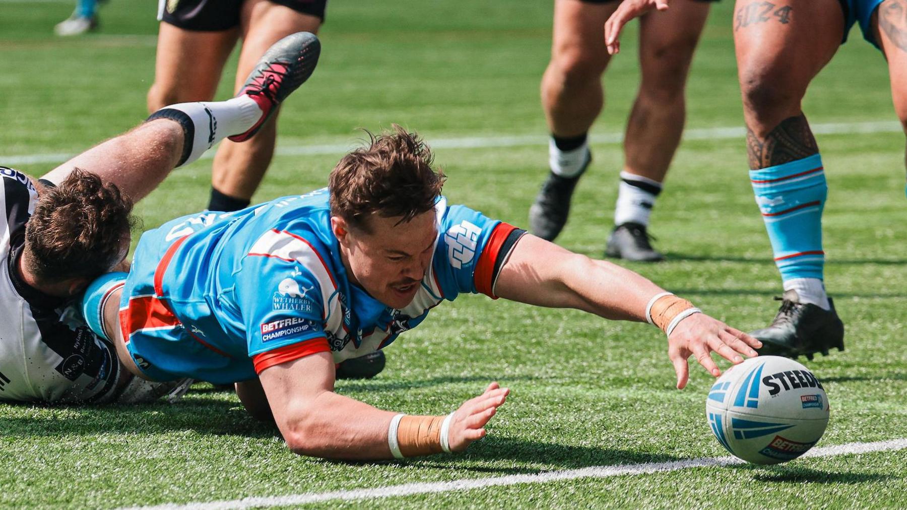 Luke Bain attempting to ground the ball for a try against Widnes Vikings 