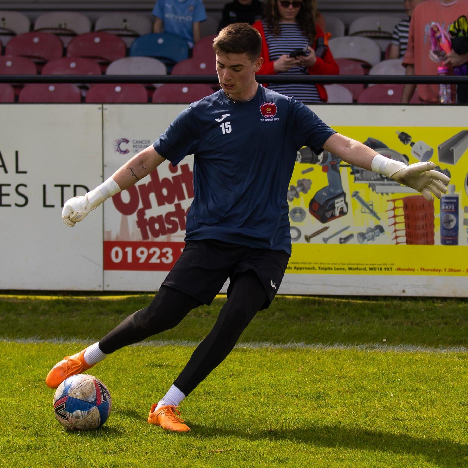 Jack Marshall kicking a ball in football kit