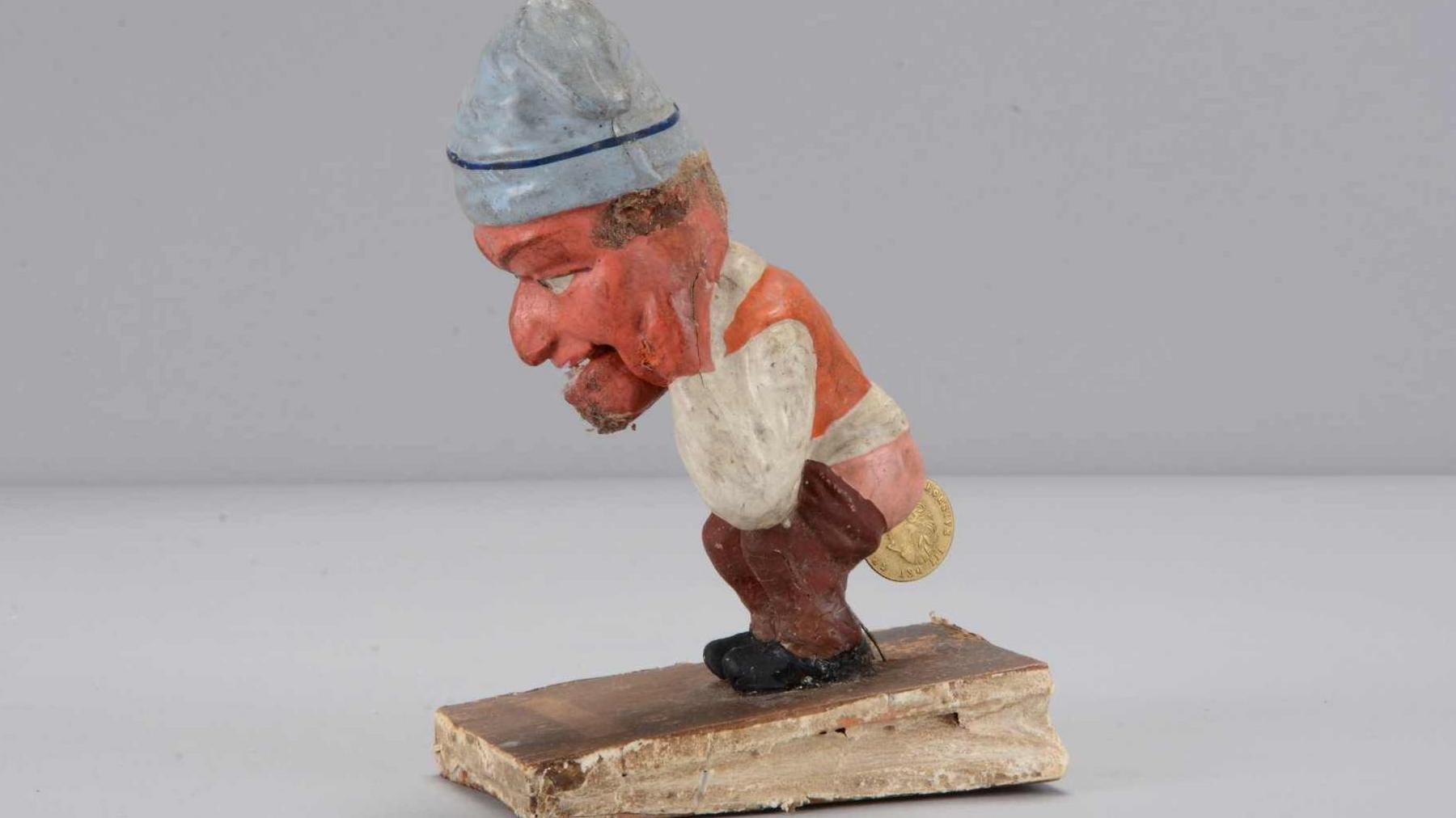 A mid 19th century Thüringen Dukatenscheißer man offloading a money squeak toy worth between 300-500