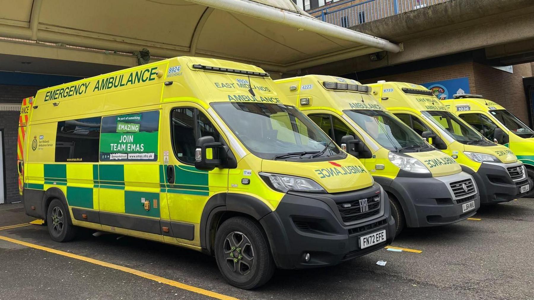 A row of ambulances outside a hospital