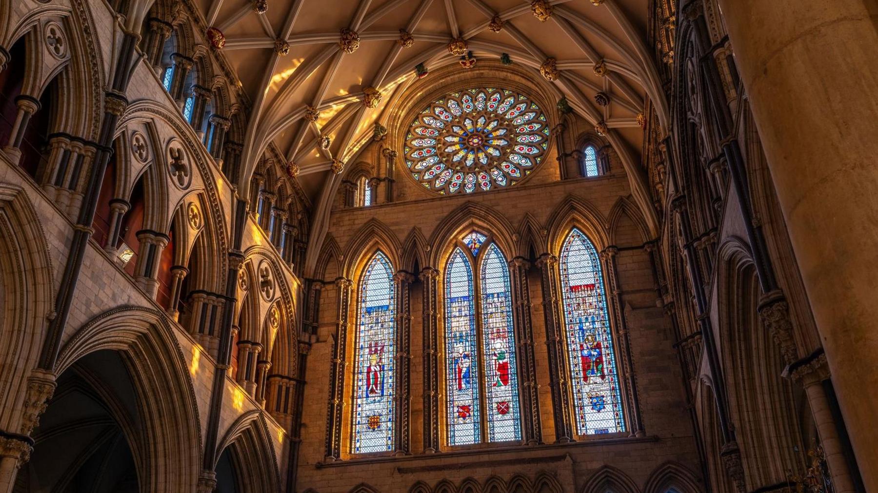 Three stained-glass lancet windows in York Minster depict Saints Peter, Paul, Wilfred, and William of York.