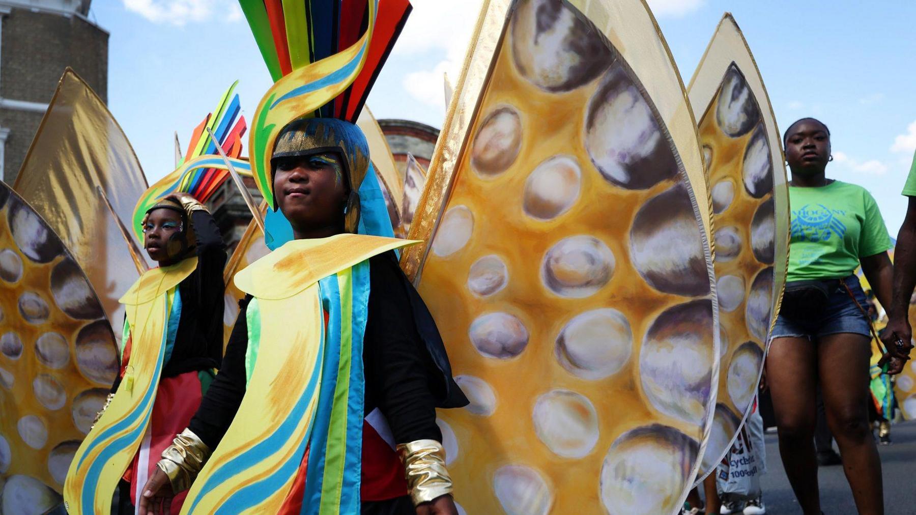 Children wearing colourful costumes.