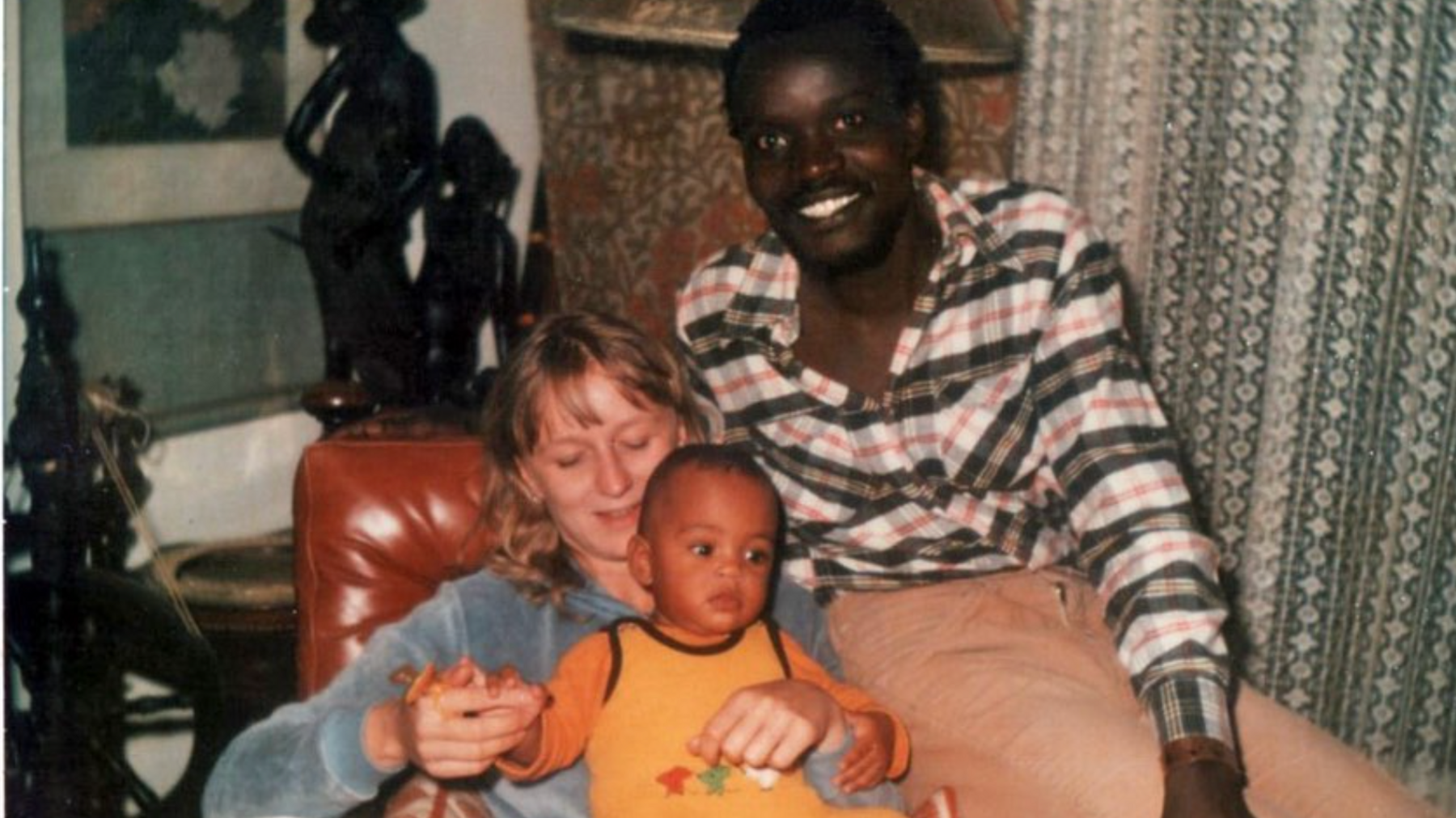 Alexandra Ndolo as a baby with her mother and father