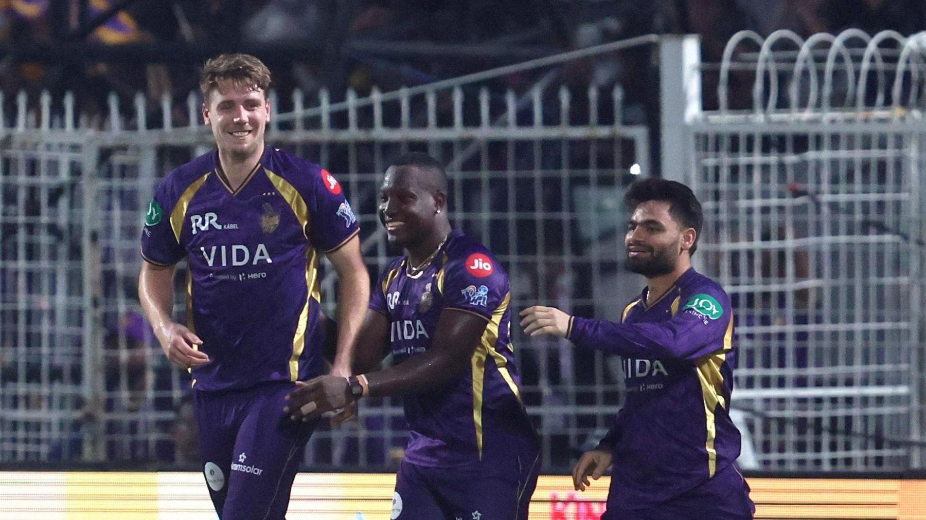 Kolkata Knight Riders' Cam Green (left) celebrates a wicket with Rovman Powell (centre) and Rinku Singh 