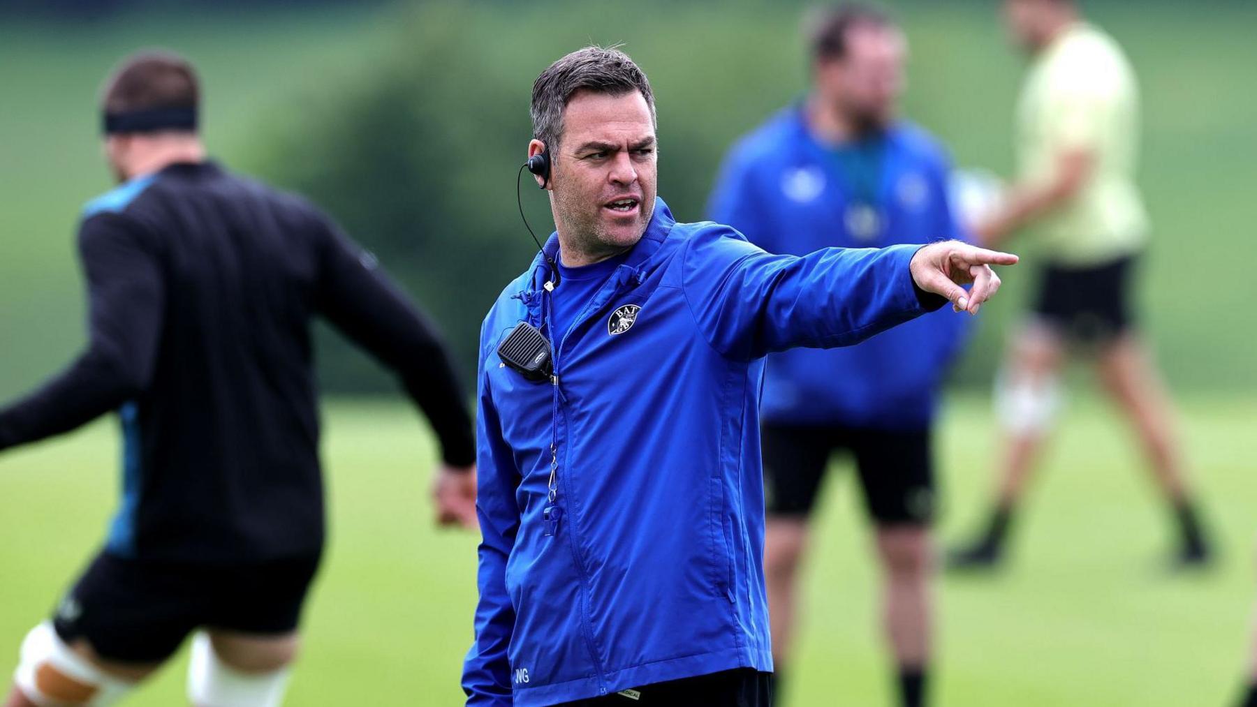 Johann van Graan points during a training session