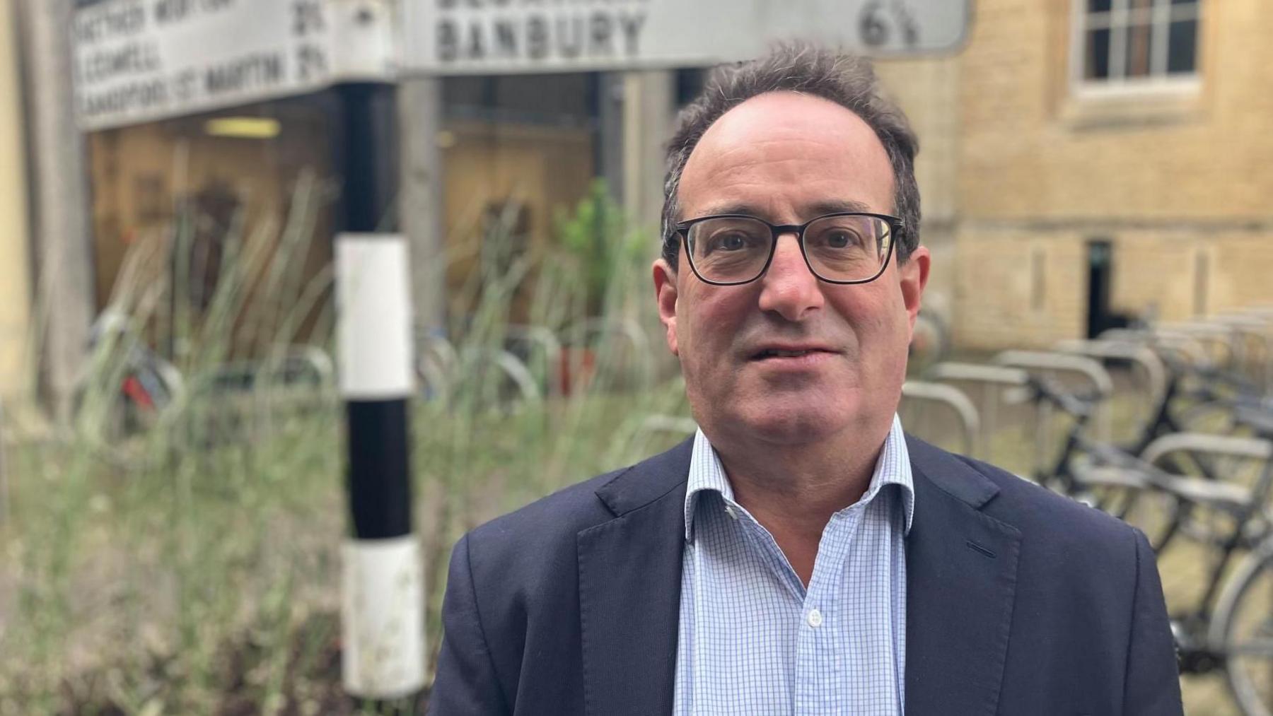 Dan Levy, who is the county councillor responsible for finance, looks directly at the camera in a picture taken outside County Hall in Oxfordshire. 