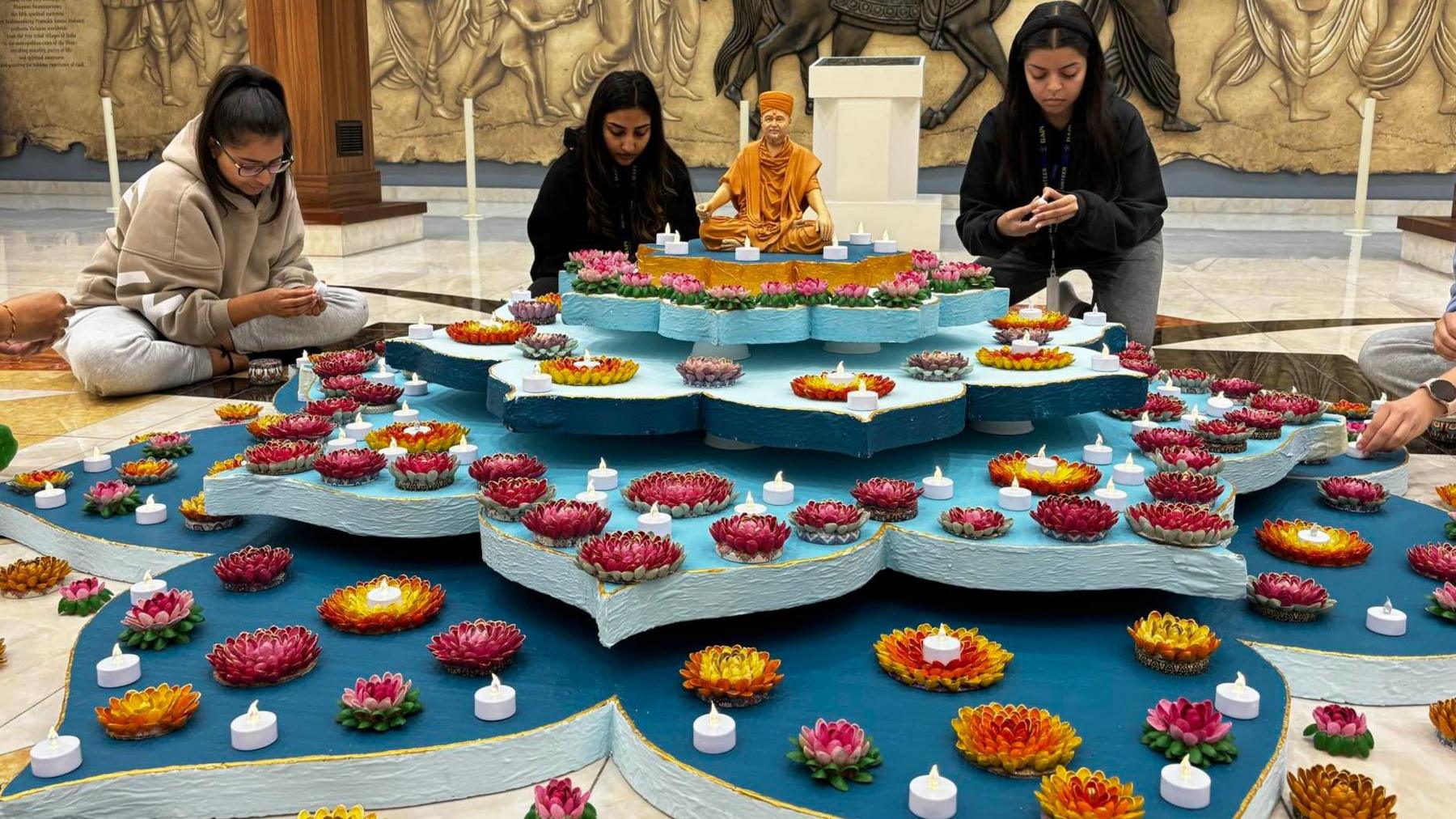 Volunteers create rangoli art inside the Shri Swaminarayan temple in Leicester