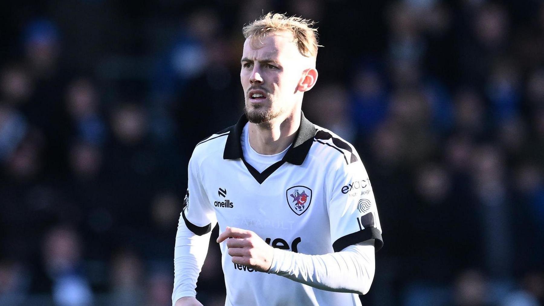 Mark Sykes jogging on the pitch during a match