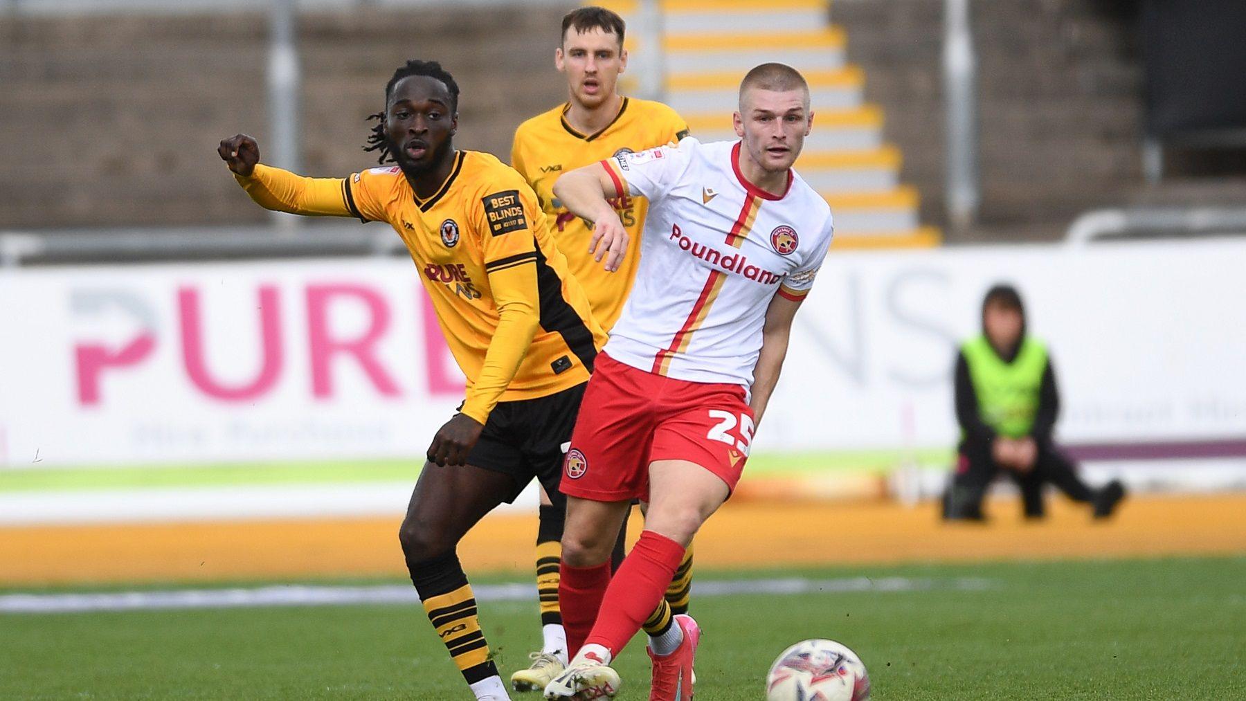 Cameron Antwi of Newport County is challenged by Ryan Stirk of Walsall