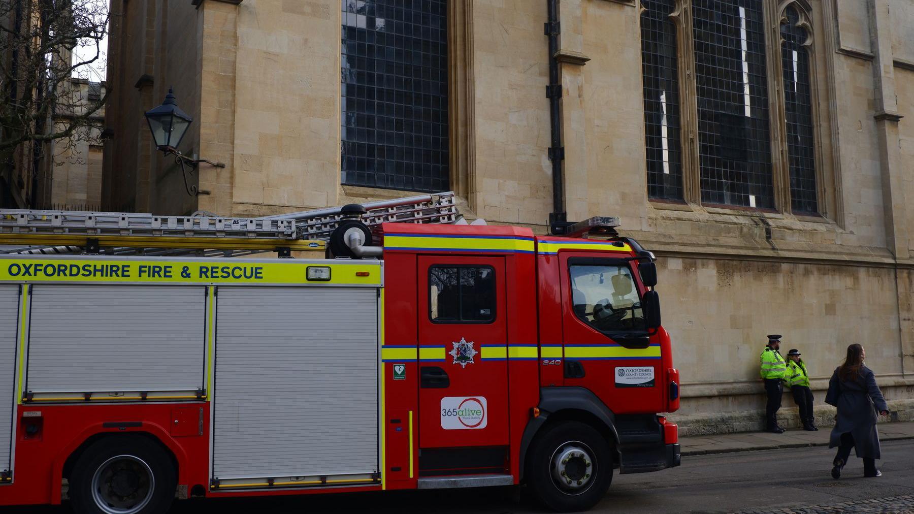 A red fire truck parked in front of an old looking building