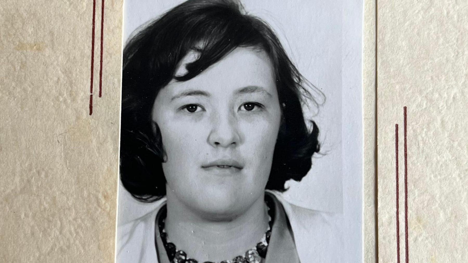 A black and white passport photo of Jan Doyle