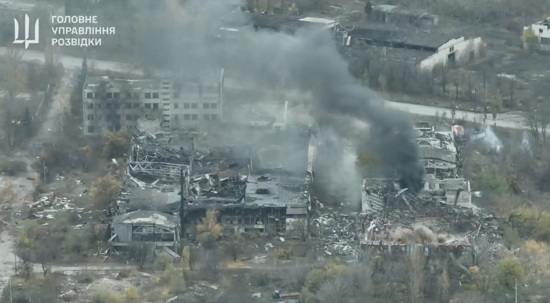 A view of destroyed buildings in Pokrovsk with the logo of Ukraine's Main Directorate of Intelligence in the top left corner