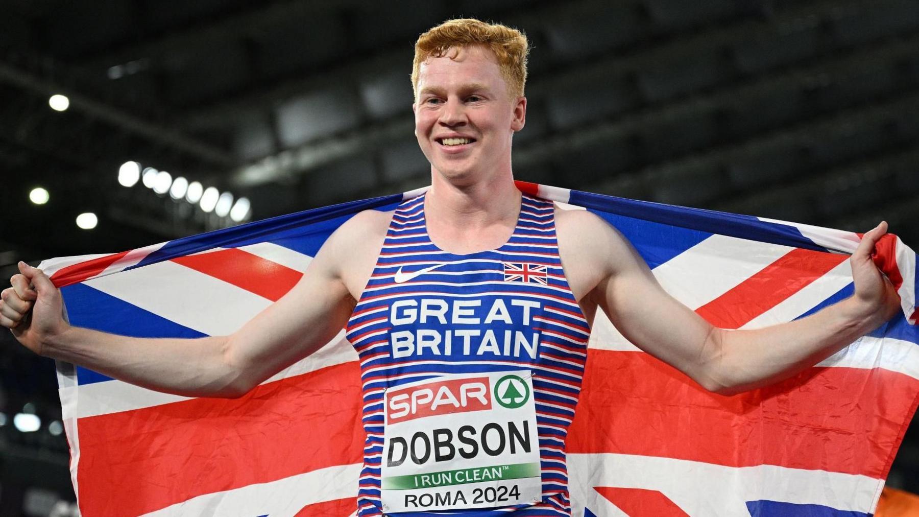 Charlie Dobson celebrates with a British flag