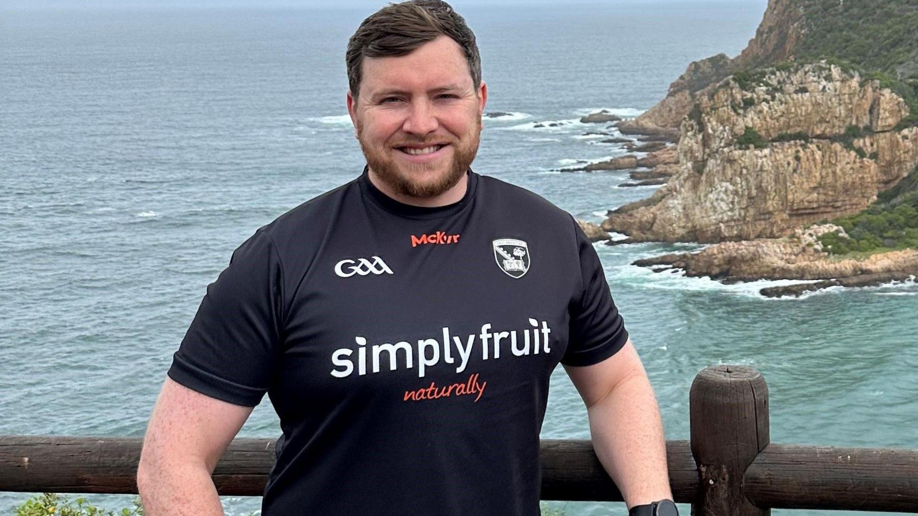 Matthew McCarthy wearing black Armagh GAA jersey, pictured in South Africa during his honeymoon