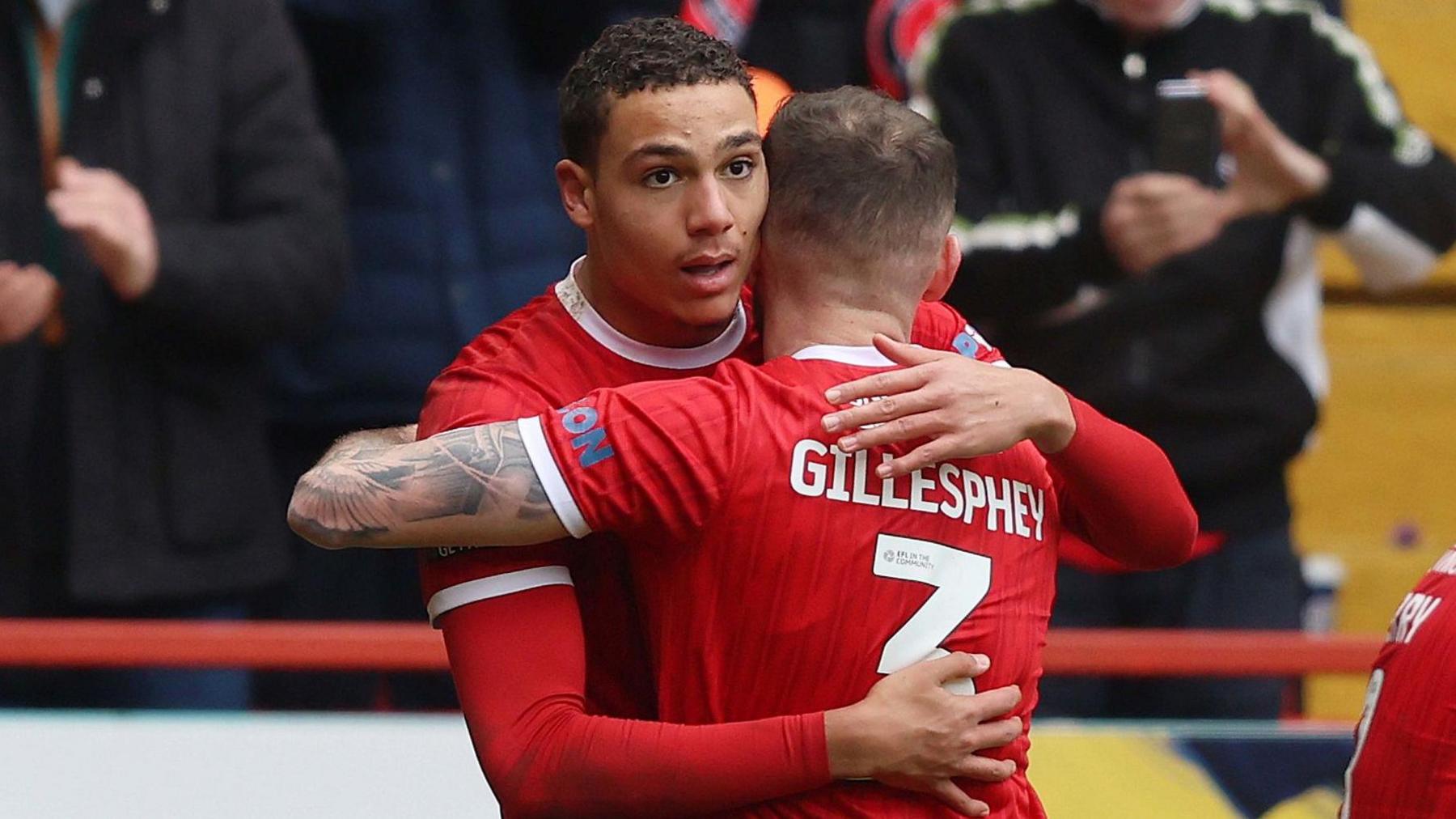 Charlton's Miles Leaburn receives a congratulatory hug after scoring against Wycombe