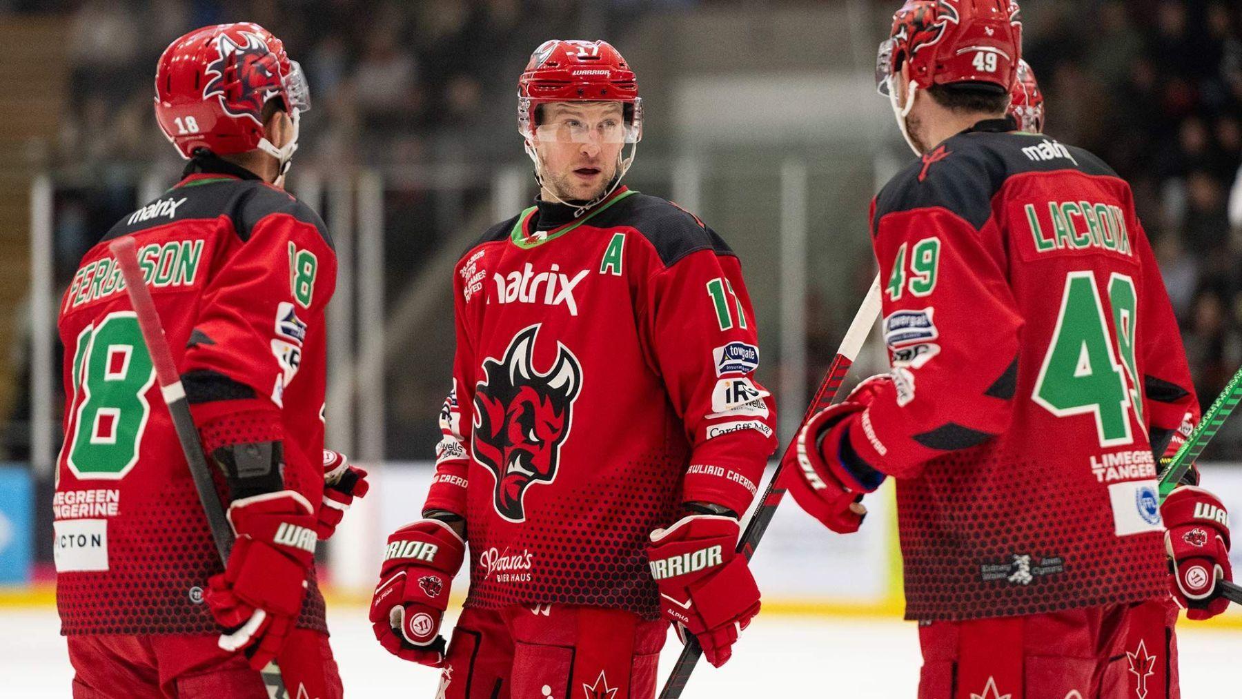 Three Cardiff Devils players in conversation.