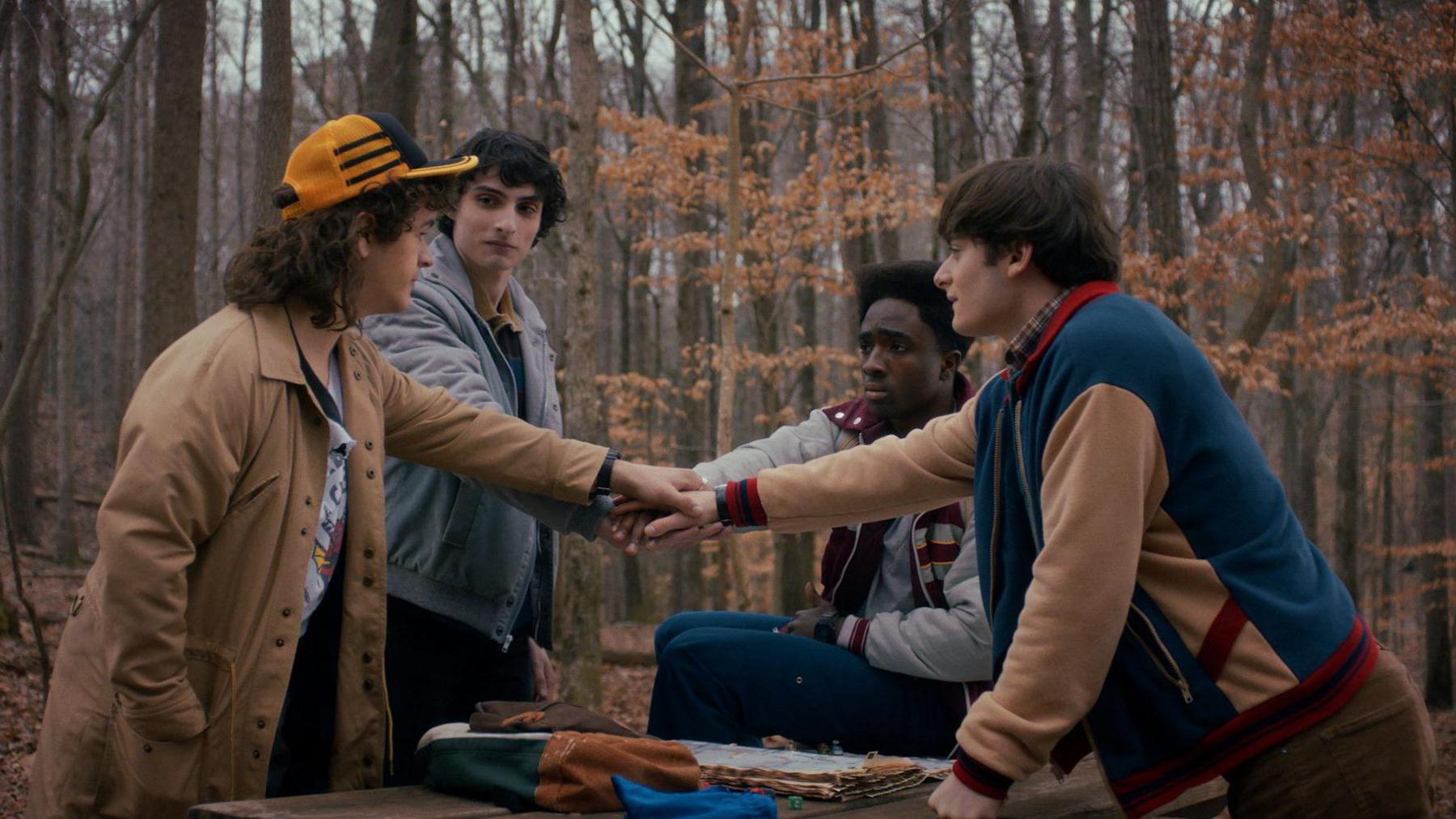 The four main characters meeting in a wood