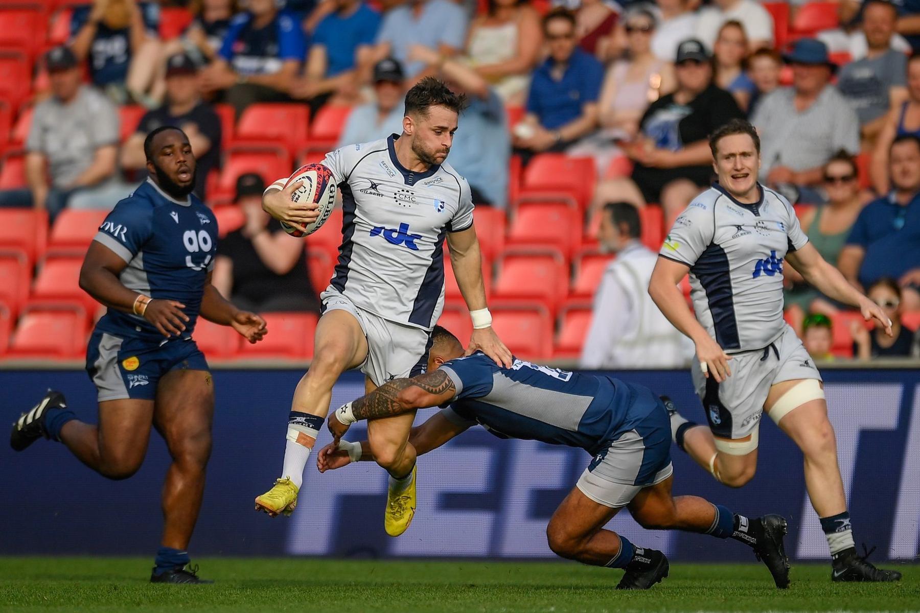 Dean Adamson is tackled as he carried the ball forward in attack for Bedford