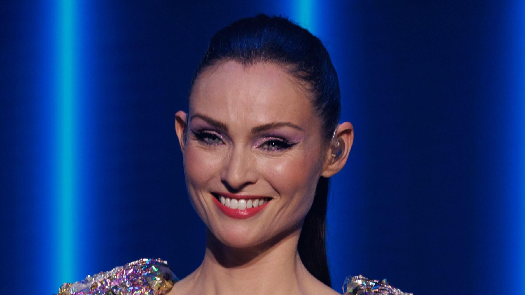 Sophie Ellis Bextor at her New Year's Eve Disco concert for BBC One, she is smiling and has her dark hair scraped back in a high ponytail