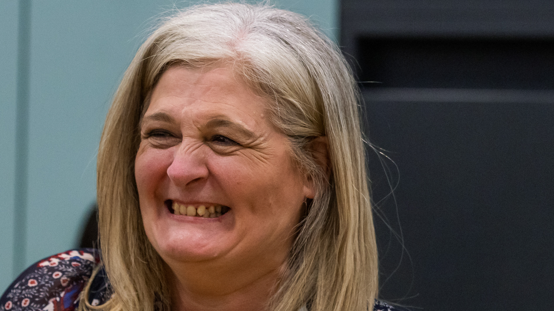 Lynne Jones smiling broadly after her election. She has blonde, shoulder length hair 