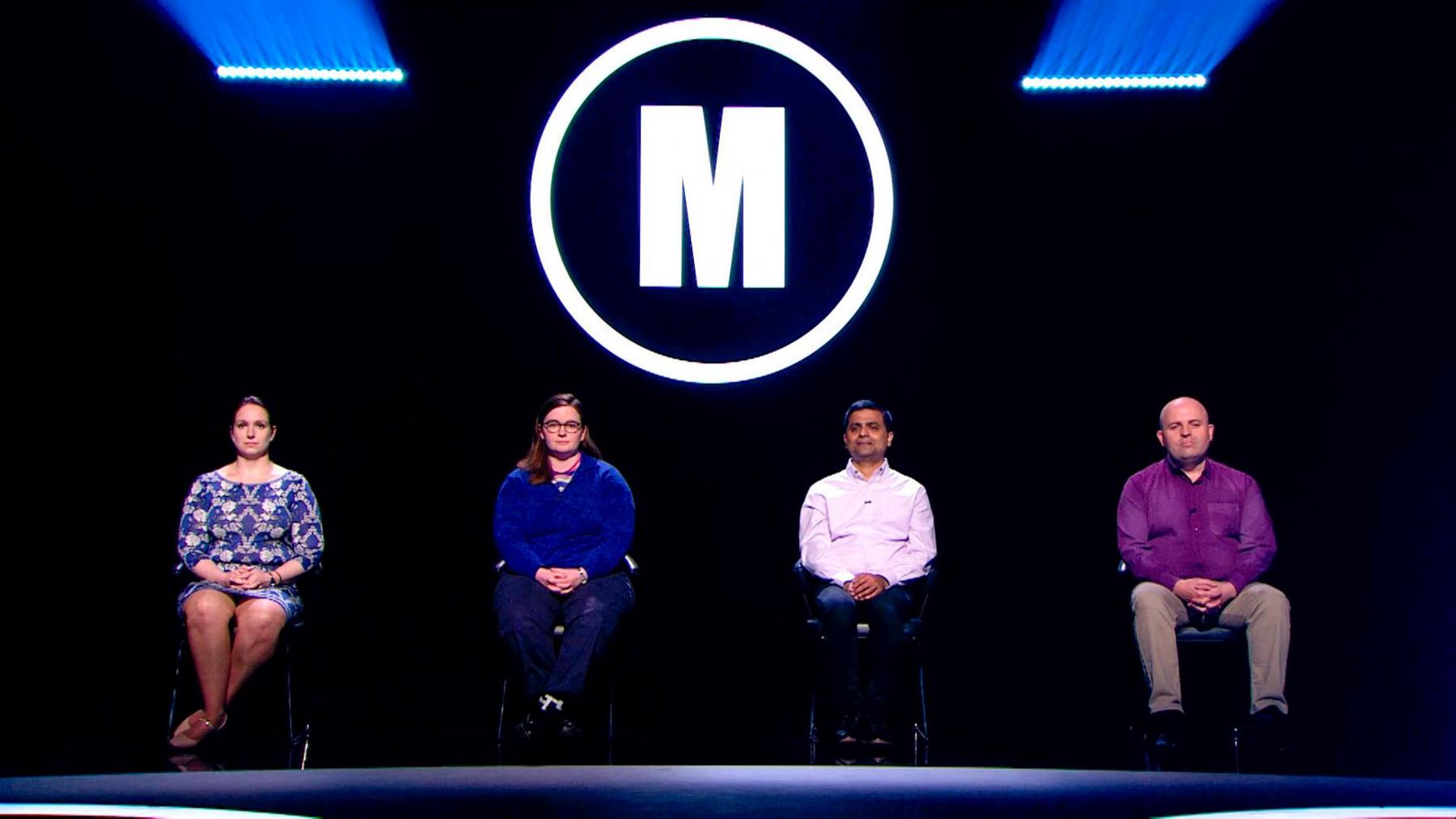 Four contestants - two female and two male - sit in chairs facing the camera in a black studio, with the Mastermind 'M' logo above them, and two strips of blue lighting.