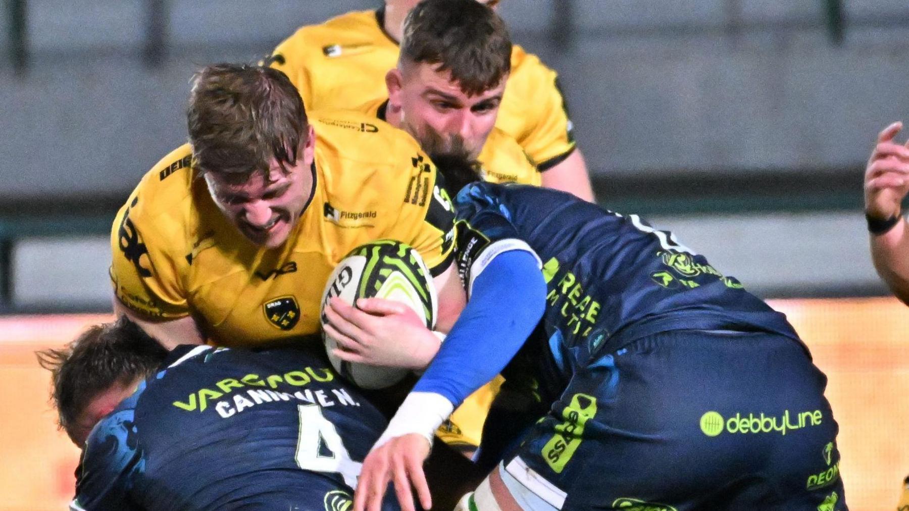 Dragons lock Matthew Screech winces as he carries the ball into the Benetton defence