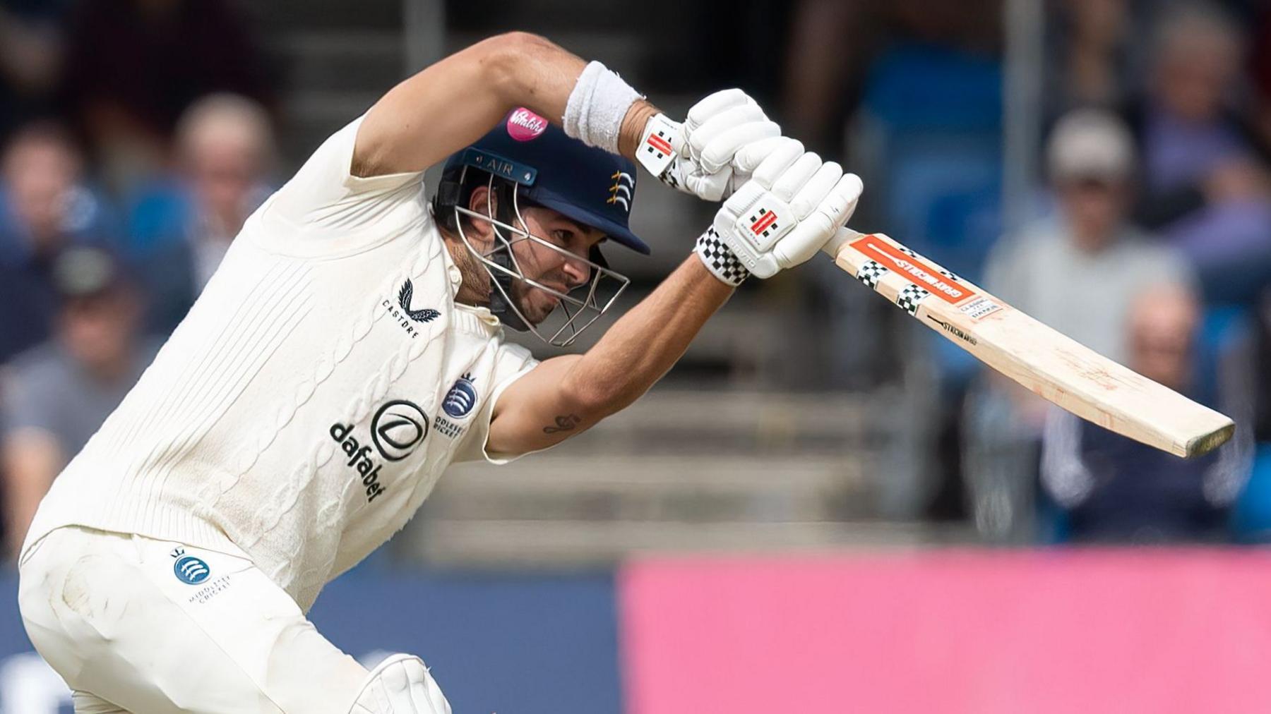 Middlesex batter Max Holden plays a shot