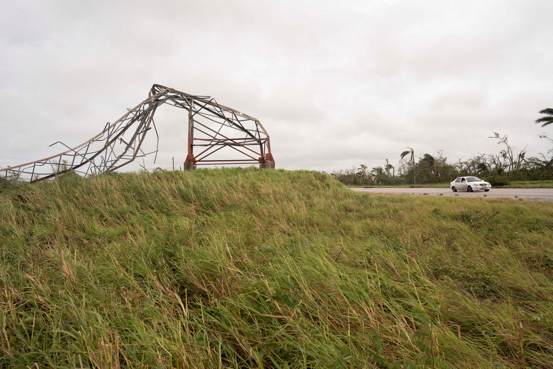 Car passes a toppled pylon on a motorway