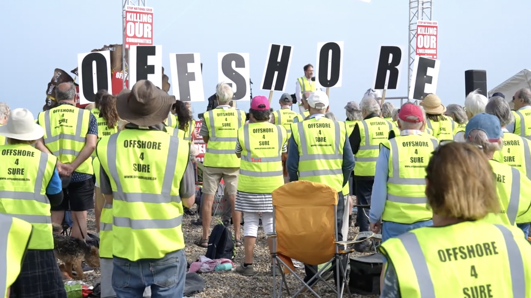 Protesters holding up signs that read 'Killing our communities'. They are wearing high-vis jackets with "Offshore4Sure" written on the back