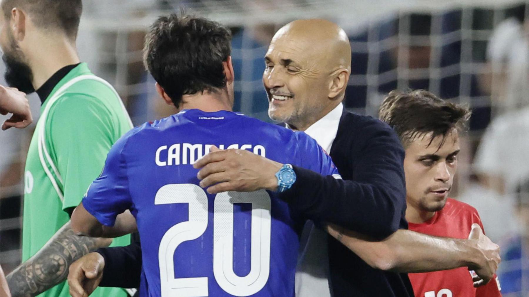 Full-back Andrea Cambiaso hugs head coach Luciano Spalletti after Italy's win over Moldova