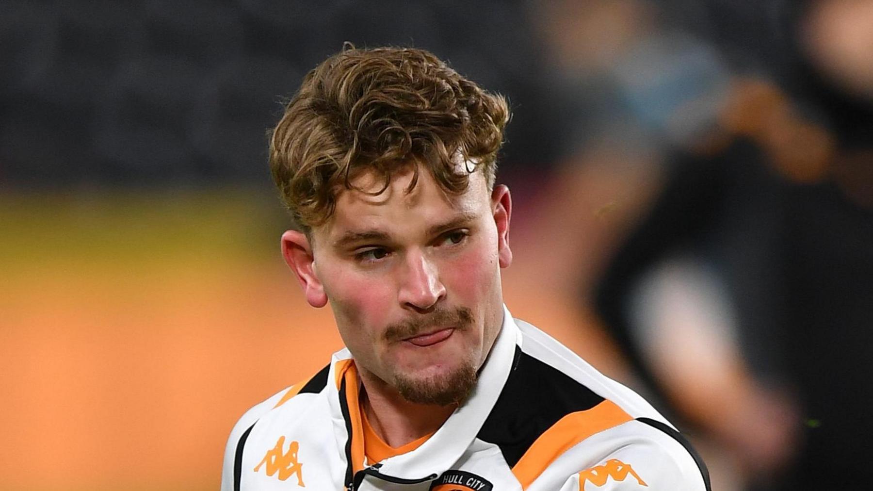 Hugh Parker warming up for a Hull first-team game in December, wearing a white sweatshirt