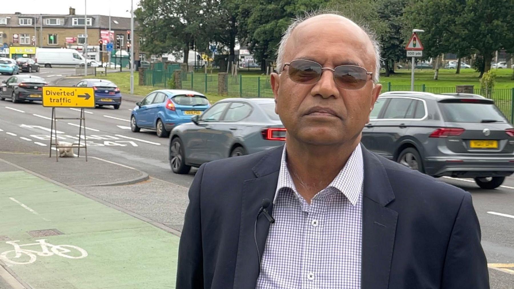 Councillor Riaz Ahmed in front of the cycle path