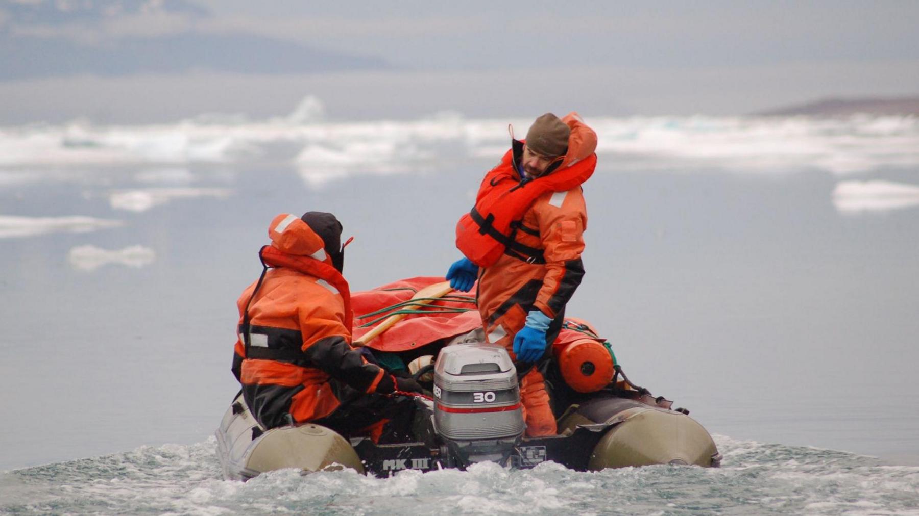 Aboard an inflatable boat at night during a research expedition to East Greenland in 2009.
