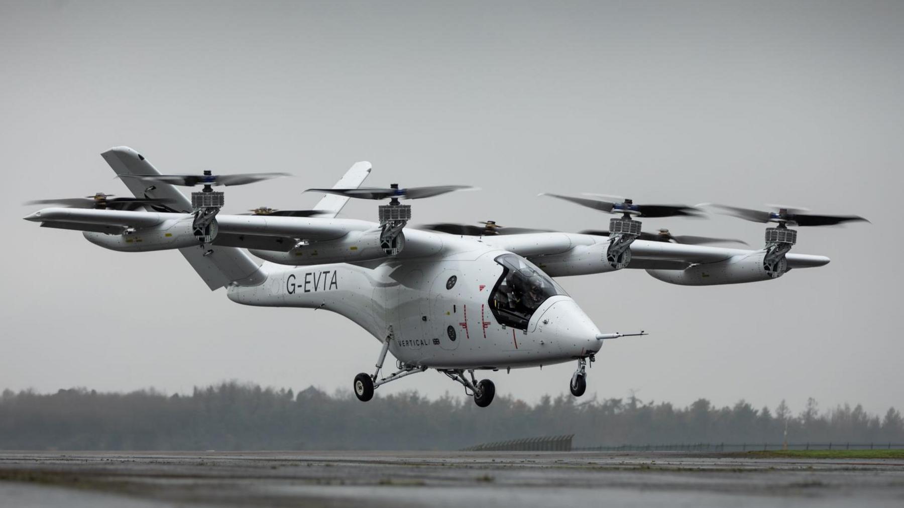 The VX4 prototype aircraft from Vertical Aerospace takes off. It has four propellers which can rotate. 