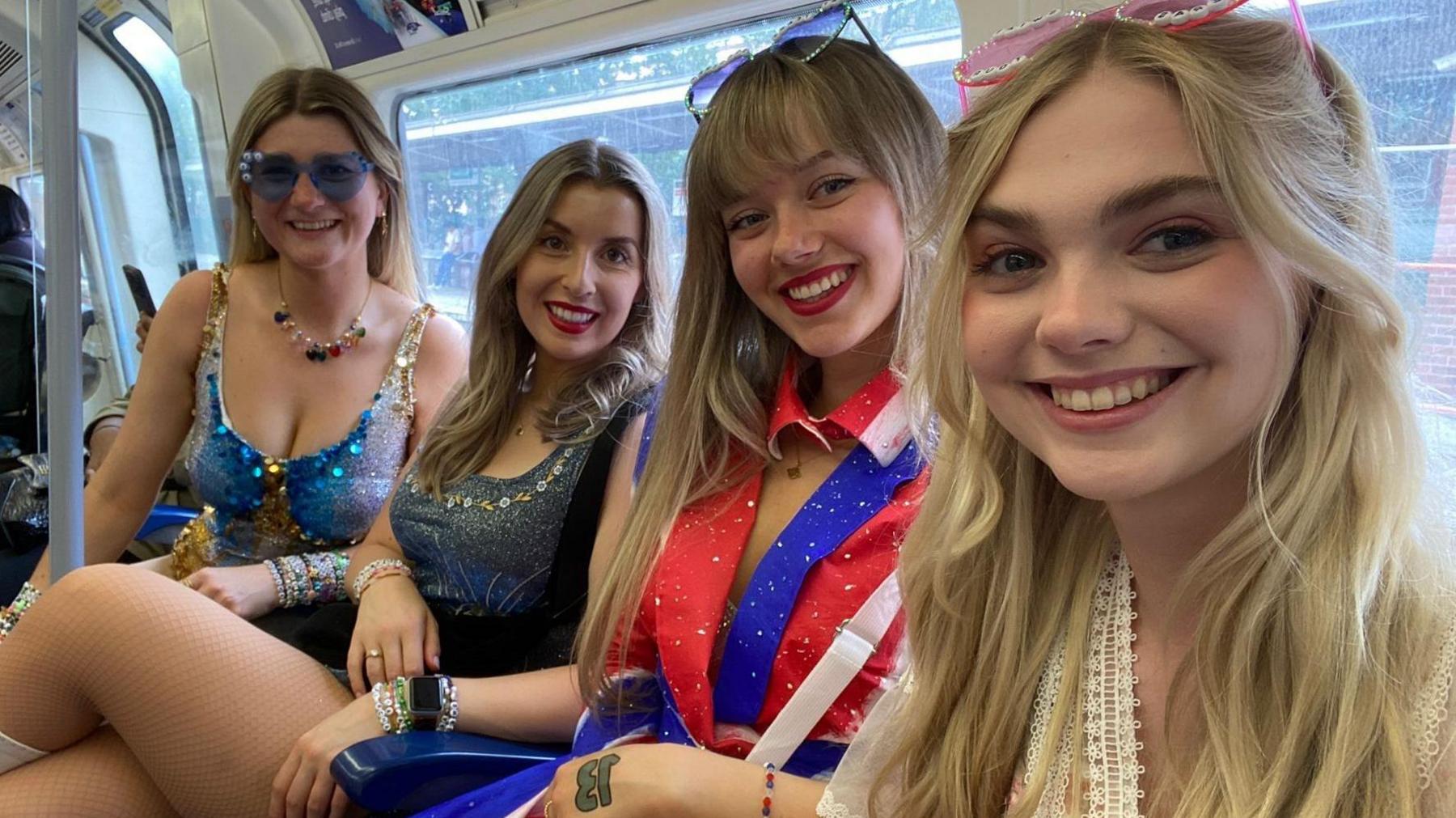 Four women sitting on London Underground train