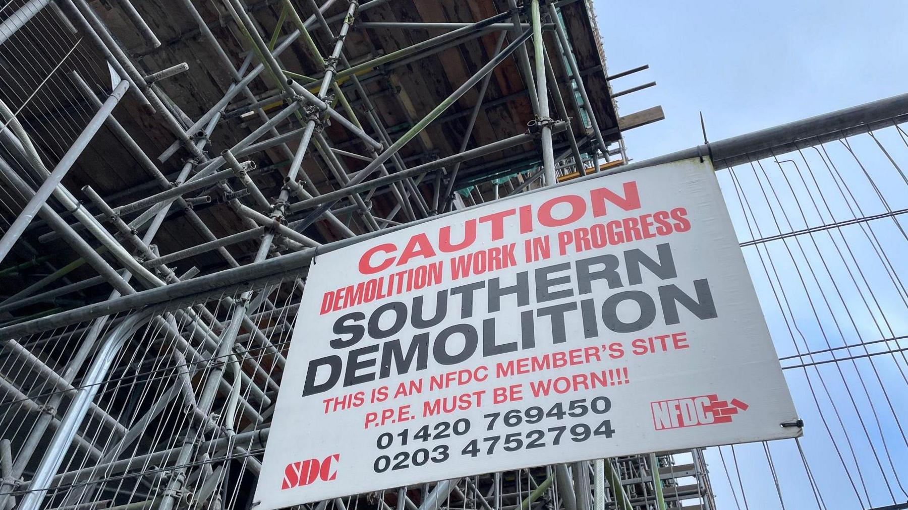 Demolition sign on scaffolding