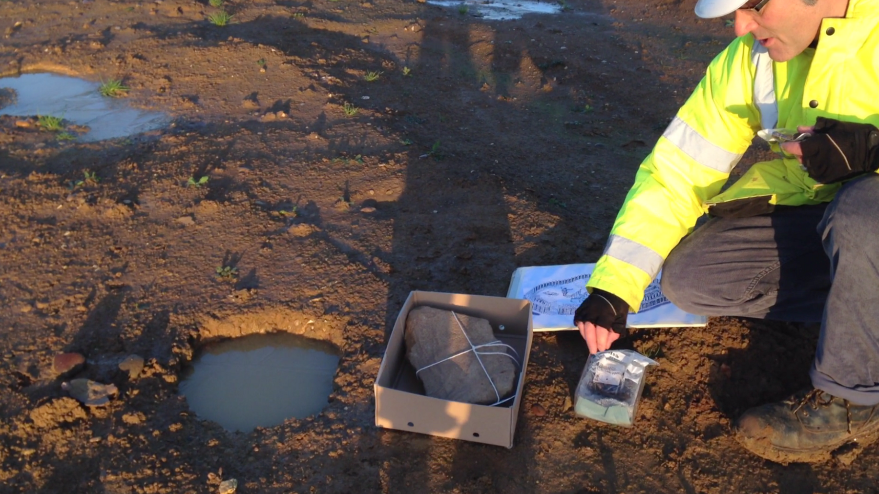 Academic examines artefacts in a field