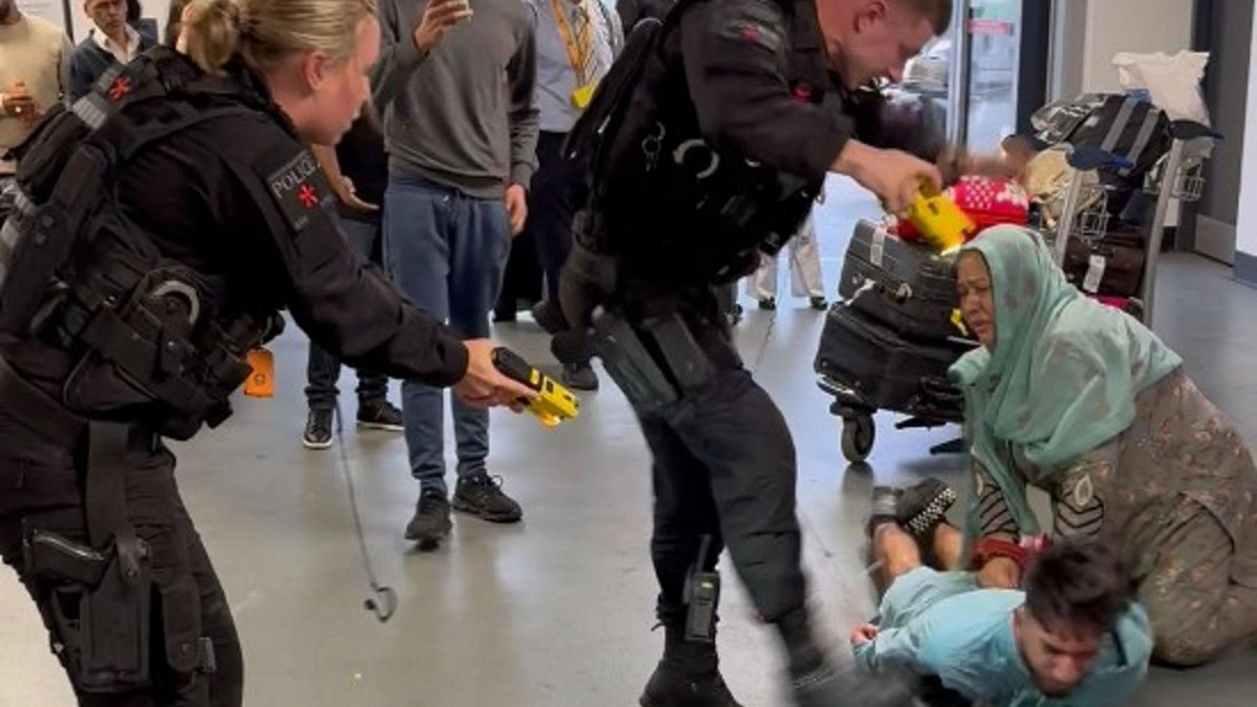 A CCTV still of Mohammed Fahir Amaaz, 20, on the floor during the alleged assault of three police officers at Manchester Airport which has been shown to jurors at Liverpool Crown Court.