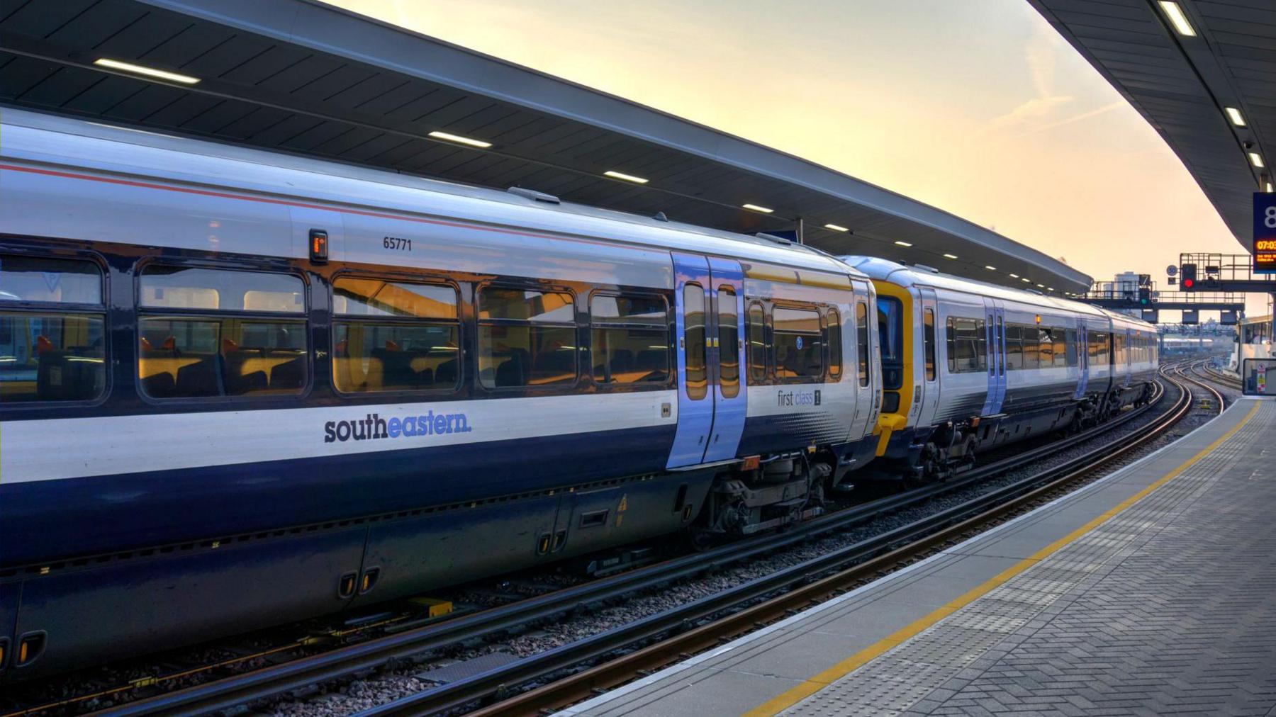 A white Southeastern train with blue doors waiting at platform at London Bridge station