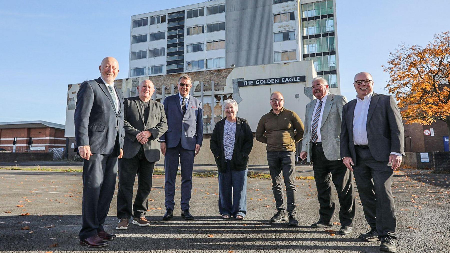 Members of the Thornaby Town Deal Board stand in front of the Golden Eagle. From left, they are Andy McDonald, MP for Middlesbrough and Thornaby East, Steve Walmsley, Mark White CBE DL, Councillor Sylvia Walmsley, Councillor Ray Godwin, Councillor Ian Dalgarno and Councillor Nigel Cooke. Much of the Golden Eagle building is boarded up.