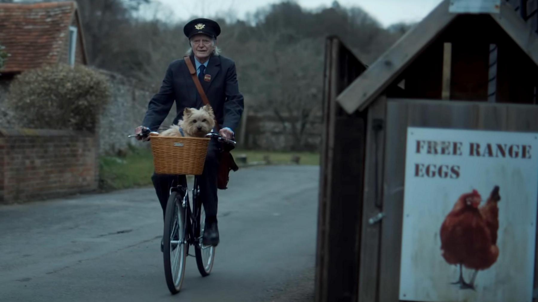 Winnie being carried on a bike by David Bradley