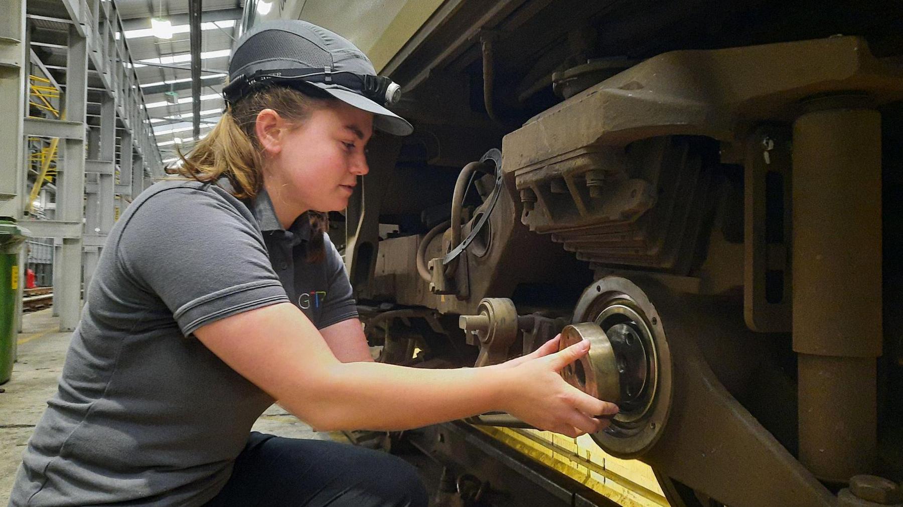 Katie Short working on a train wheel